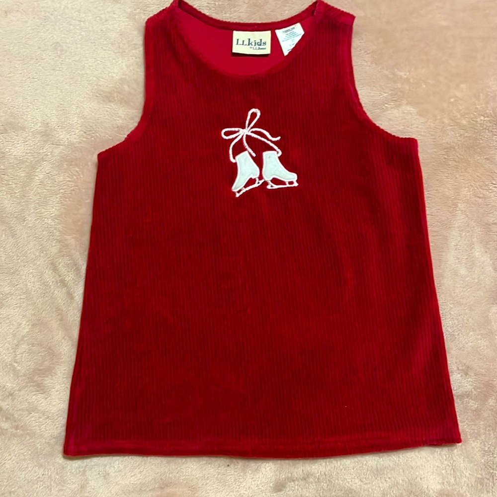 Red little girl’s dress with cute ice skate detail on front.